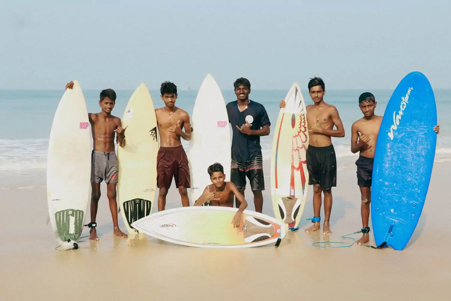 Group of young surfers with surfboards during a foundation development program