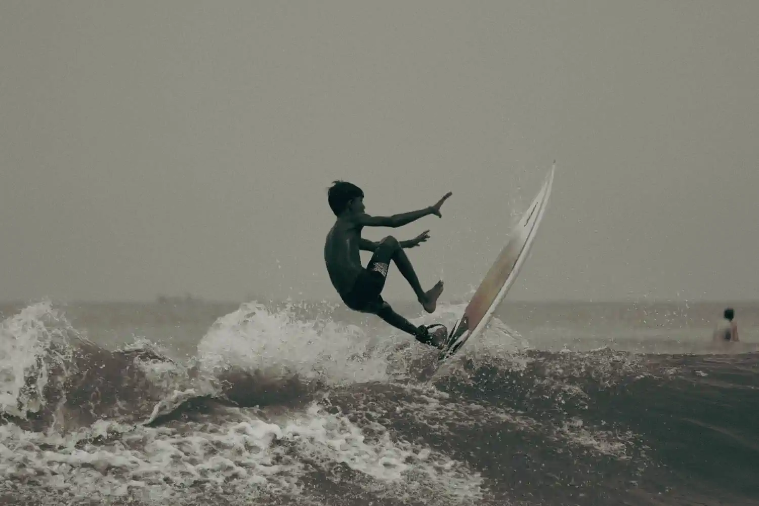 Coach guiding a young surfer during a foundation training session