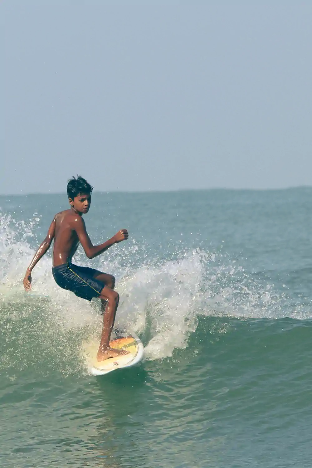Young surfer practicing in the water during a foundation training session