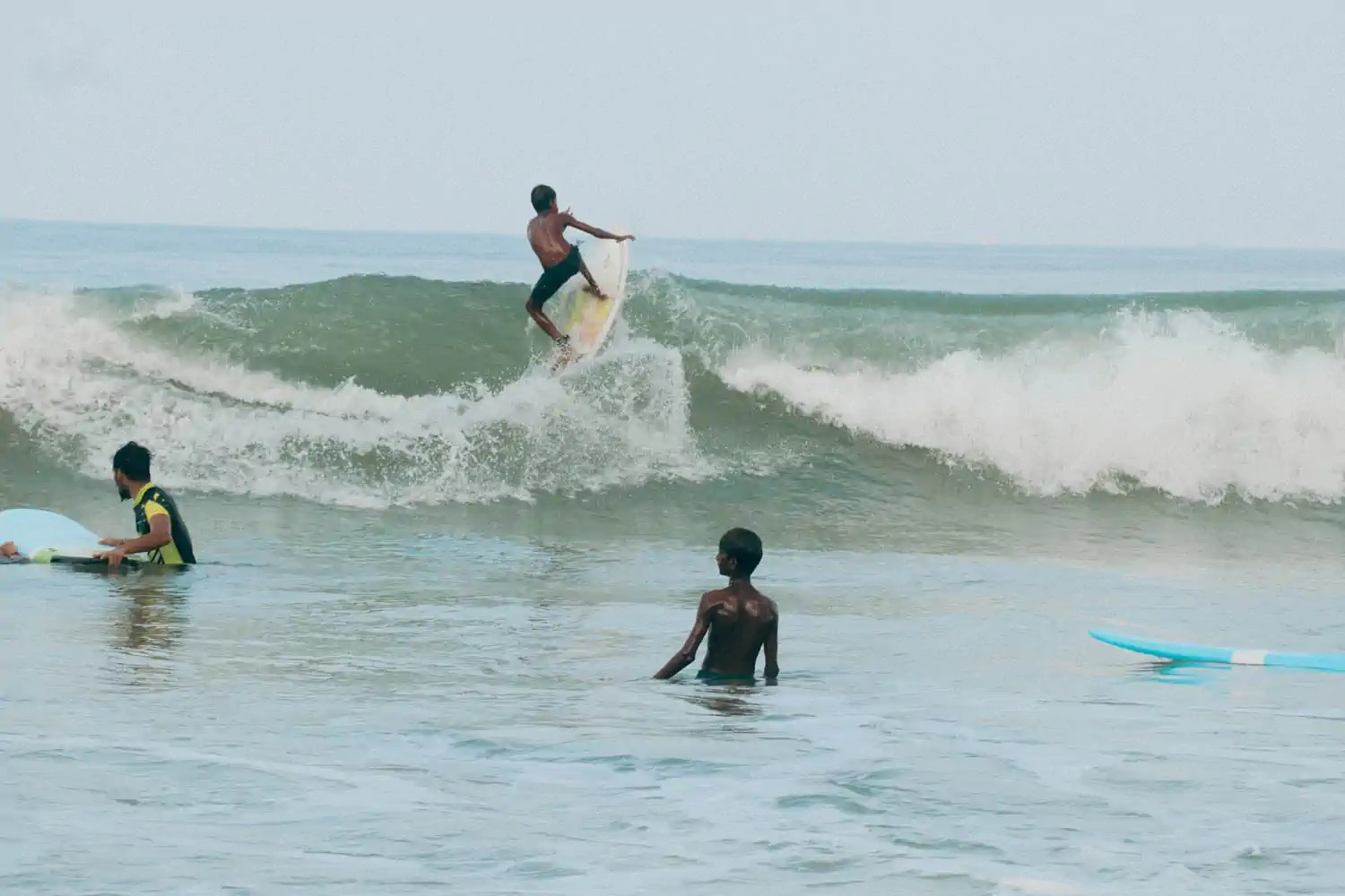A supervised surfing session representing learning, mentorship and progression